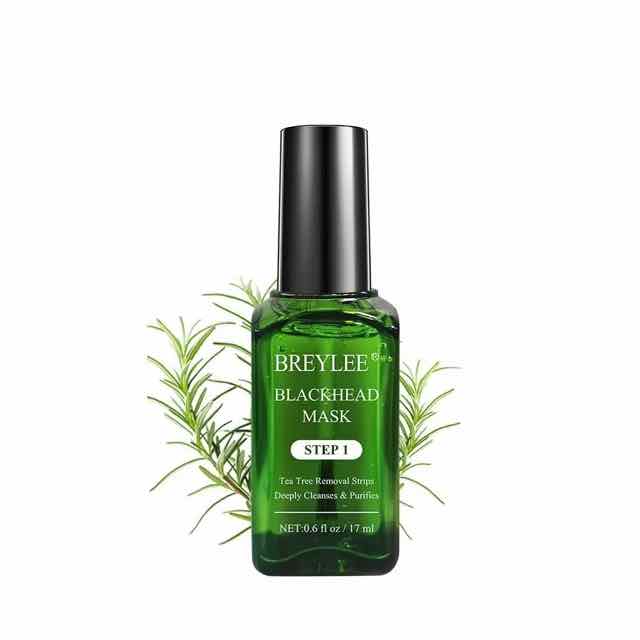 Green tea tree blackhead mask bottle with black cap and rosemary-like leaves behind it on a white background.